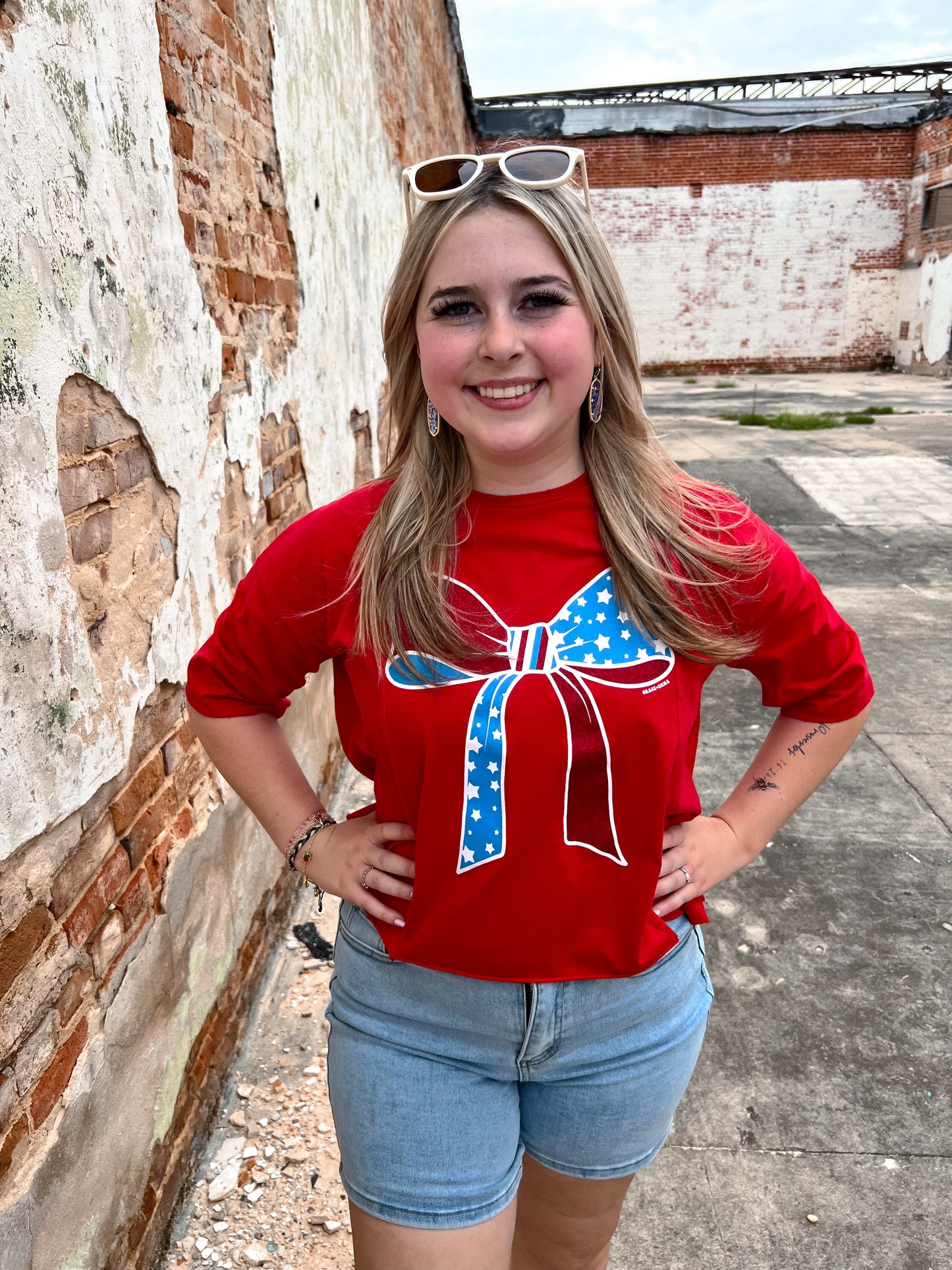 Red White And Blue Bow Tee Shirt-Apparel & Accessories-Southern Grace Wholesale-06/18/25,6893e-red-bow,FD 04/09/24,Max Retail,Tops Collection-The Twisted Chandelier